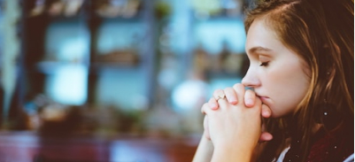 Woman praying.  Image by Ben White on Unsplash.