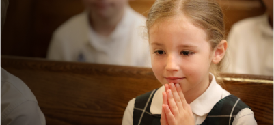 Little girl praying in church