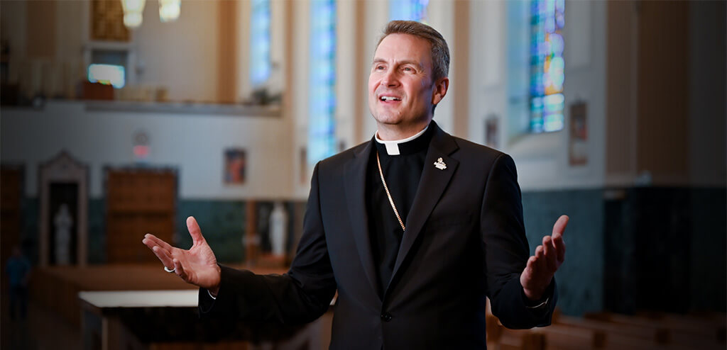 Image of Bishop Hicks with his arms open.